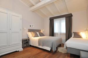 a bedroom with two beds and a window at Baita Fanti Ski & Bike in Bormio