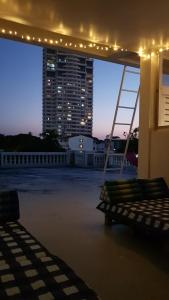 a rooftop with swings and a large building with lights at DoubleTree House in Chiang Mai