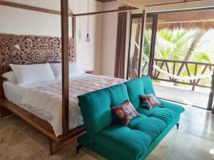 a bed that has a blanket on top of it at Azucar Hotel Tulum in Tulum