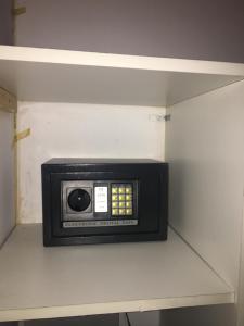 a small microwave on a shelf in a room at Santa Teresita en el monte in Santa Teresita