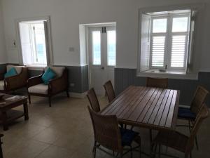 a dining room with a table and chairs and windows at The Atlantis Historic Inn in Saint Joseph