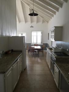 a kitchen with a table and a dining room at The Atlantis Historic Inn in Saint Joseph