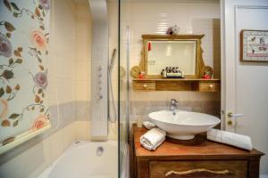 a bathroom with a sink and a shower and a tub at Contessina Apt. in Corfu Town +105 photos