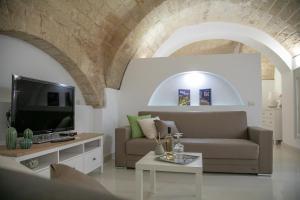 a living room with a couch and a tv at Ta Maison Bari in Bari