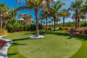 a golf course with a palm tree and golf balls at Bella Vista in Fort Pierce