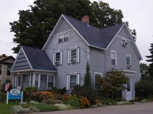 a large gray house with a black roof at Four Creeks Bed&Breakfast in Fairview