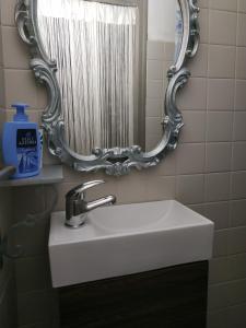 a white sink in a bathroom with a mirror at Vista mare vecchia città in Menton