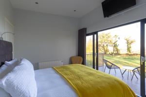 a bedroom with a bed and a tv at The View at Moneylands in Arklow