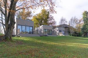 a house on a lawn with a tree at The View at Moneylands in Arklow