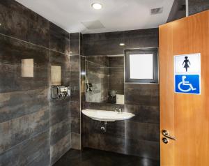 a bathroom with a sink and a shower at Hotel Puerta de la Santa in Avila