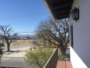 a balcony of a house with a view of a street at Dpto. Tribuno in Salta