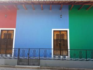 a row of colorful houses with doors at Lovely new-build colonial house with plunge pool in Granada