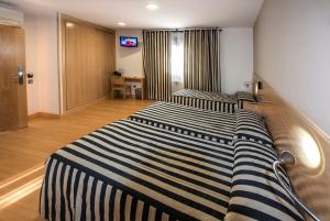 Cama o camas de una habitación en Hotel Puerta de la Santa