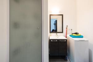 a bathroom with a sink and a mirror at Appart République parking privé gratuit in Lille