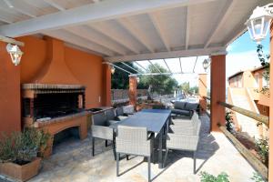a patio with a table and chairs and a fireplace at Pyramid City Apartments in St. Spyridon Corfu