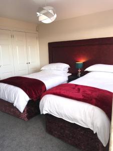 a bedroom with two beds and a large headboard at The Flat Axbridge in Axbridge