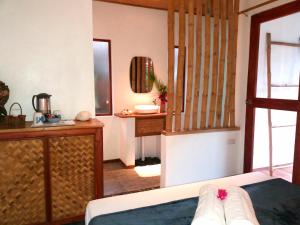 a room with a bed and a sink and a mirror at Valerie Lodge in San Vicente