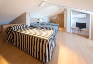 Cama o camas de una habitación en Hotel Puerta de la Santa