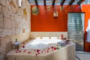 bañera en una habitación con paredes rojas en Moonshine Hotel en Playa del Carmen