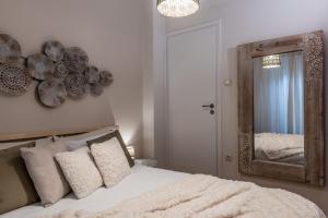 a bedroom with a bed with a mirror on the wall at Acropolis, Urban Lifestyle apartment in Athens