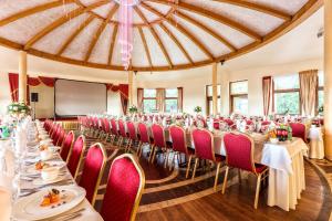 a set up for a banquet in a room with tables and chairs at Leśna Perła - Restauracja i Pokoje Hotelowe in Rudzinitz