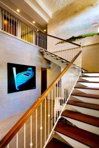 a staircase in a house with a tv on the wall at FAVIGNANA HOTEL Concept Holiday in Favignana