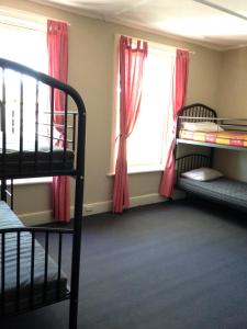 a bedroom with two bunk beds and a window at Shingo's Backpackers in Adelaide