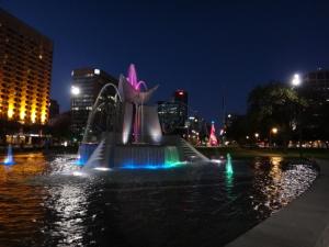 a fountain in the middle of a city at night at Shingo's Backpackers in Adelaide