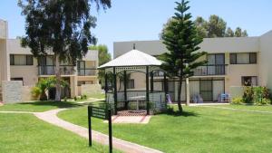 a building with a gazebo in the grass at Apt 42 Riverview Holiday Apartments in Kalbarri