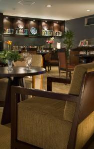 a restaurant with tables and chairs in a library at Oakwood Residence Aoyama in Tokyo