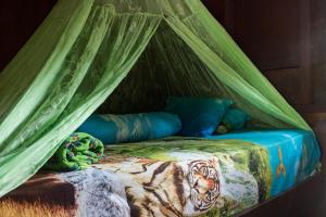 Una cama o camas en una habitación de Rain Forest Guest House and Jungle Trekking