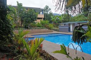 a swimming pool in front of a house at Mindo Real in Mindo