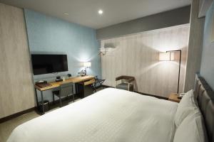Ένα ή περισσότερα κρεβάτια σε δωμάτιο στο Fulidun Hotel Kenting +37 φωτογραφίες
