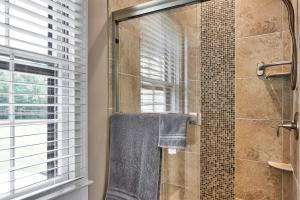 a bathroom with a shower with a glass door at Pleasanton Courtyard Bed and Breakfast in Fayetteville +25 photos