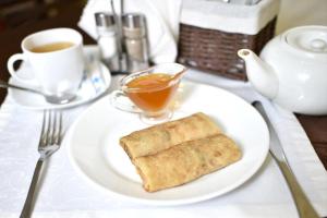 a plate with a piece of bread and a cup of coffee at Hotel Aeroport in Barnaul