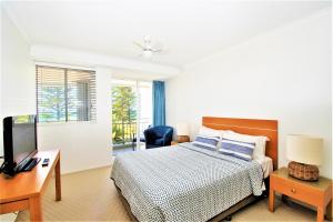 a hotel room with two beds and a television at Indigo Blue in Gold Coast