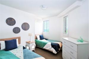 a bedroom with a bed and a desk at Indigo Blue in Gold Coast
