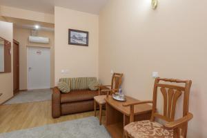 a living room with a couch and a table and chairs at Nord House in Saint Petersburg