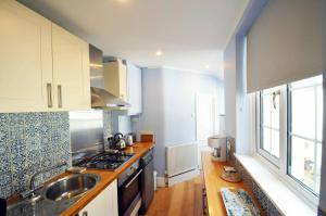 a kitchen with a sink and a stove top oven at STABLE HOUSE - Eton WINDSOR in Windsor