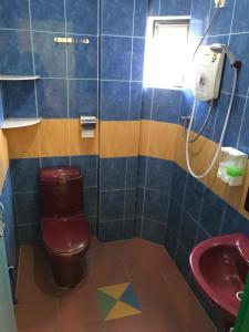 a bathroom with a toilet and a sink at Kangsar Hotel in Kuala Kangsar