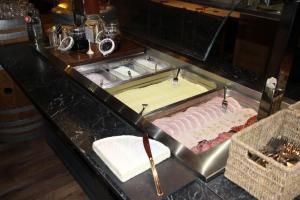 a kitchen counter with a counter top with a cake at Hotel Zodiaque in Anzère