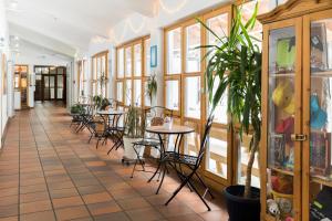 a restaurant with tables and chairs and windows at Jugendherberge Oberstdorf in Oberstdorf