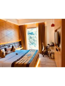 Postel nebo postele na pokoji v ubytování JRD Pride-Business Hotel