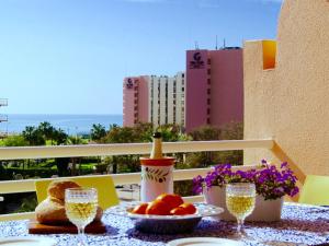 a table with a plate of food and glasses of wine at Seastar in Vilamoura