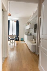 a kitchen with white cabinets and a dining room at Monolocale Casa Pepe Sorrento in Sorrento
