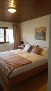a bedroom with a large bed with a wooden ceiling at Appartement Unterbergblick in Kössen