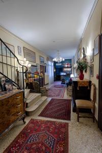 a hallway with stairs and a living room with rugs at Hotel Guerrato in Venice
