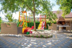 a park with a playground with a slide at Pansion Glory in Međugorje