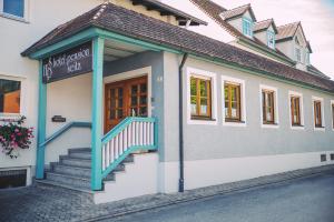 a building with a sign on the side of it at Hotel-Pension Seitz in Wolframs-Eschenbach