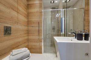 カトヴィツェにあるSilesia Luxury Apartmentsのバスルーム(白いシンク、シャワー付)